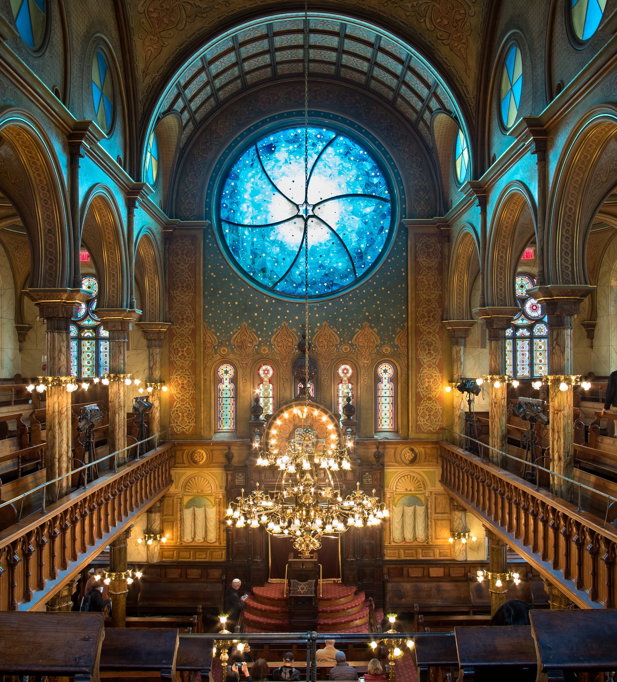 Synagogue interior with a blue stained glass window